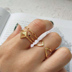 Gold rings on a finger with a blurred background