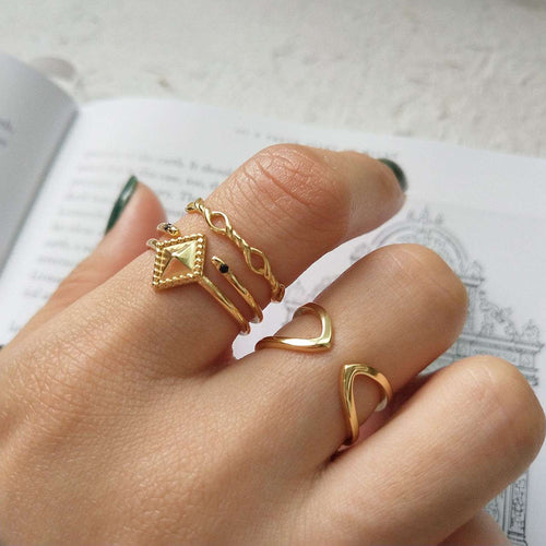 Gold rings on a finger with a blurred background