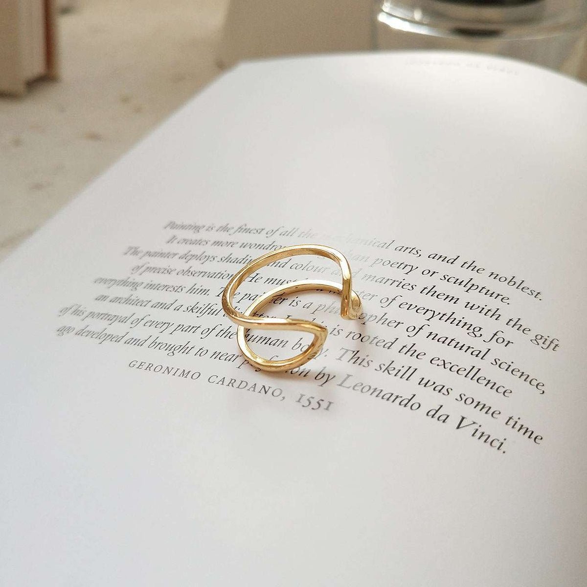 Gold ring on an open book with text