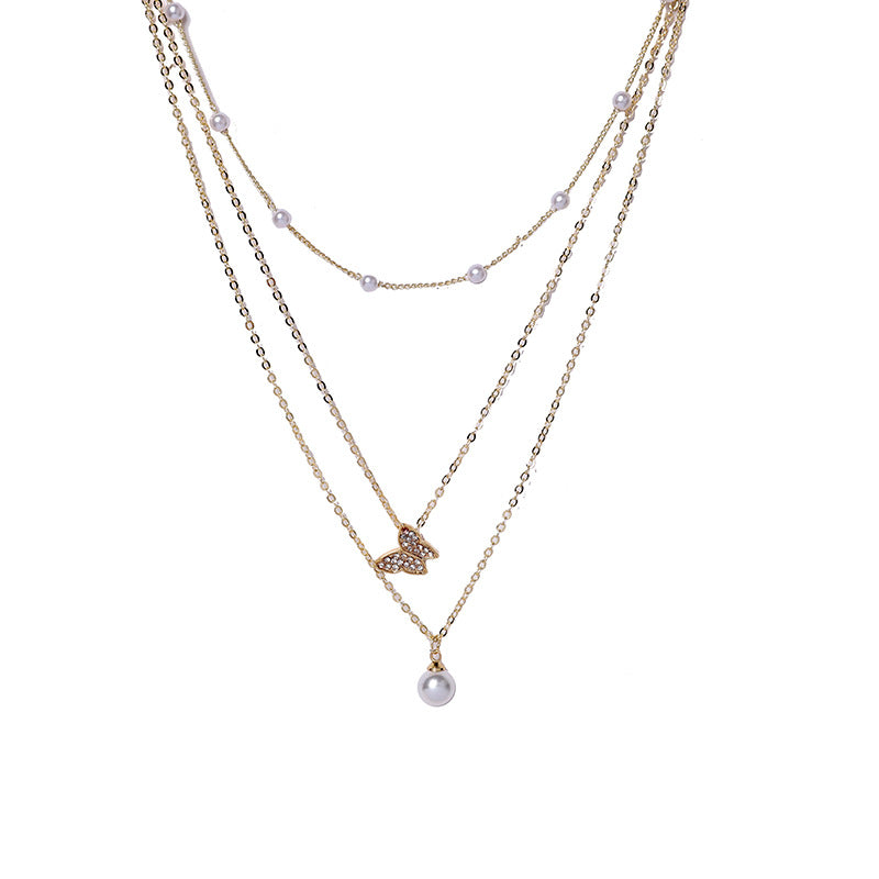 Butterfly pearl necklace close-up – feminine layered chain necklace UK