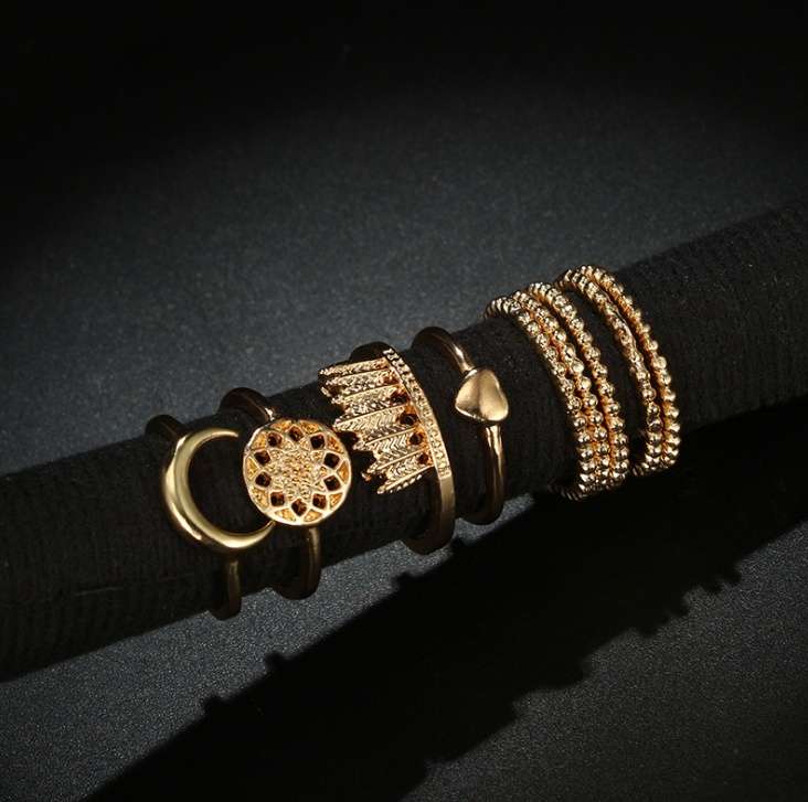 Gold rings on a black belt against a dark background