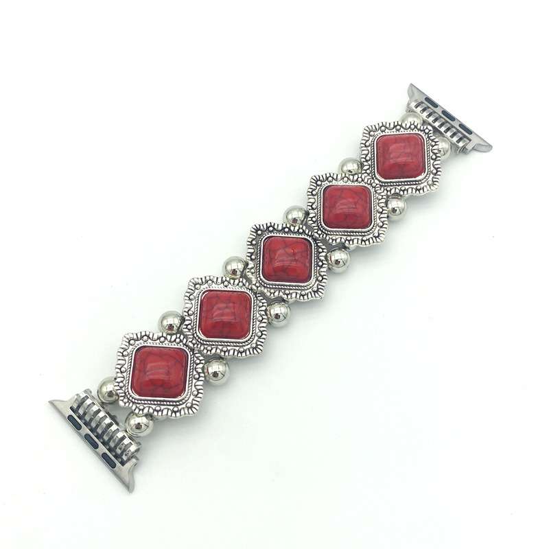 Bracelet with red square stones and silver accents on a white background