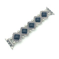 Silver bracelet with blue square stones on a white background