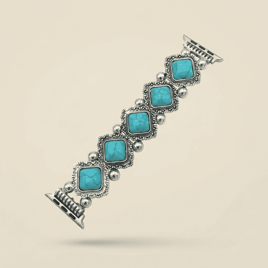 A silver-toned cuff bracelet featuring five square-cut turquoise stones in ornate settings, displayed diagonally on a light beige background.