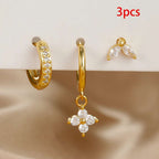 Three-piece gold hoop and dangle earrings with clear rhinestones, displayed on a white stand with a beige satin surface below. A red text overlay in the top right reads '3pcs'.