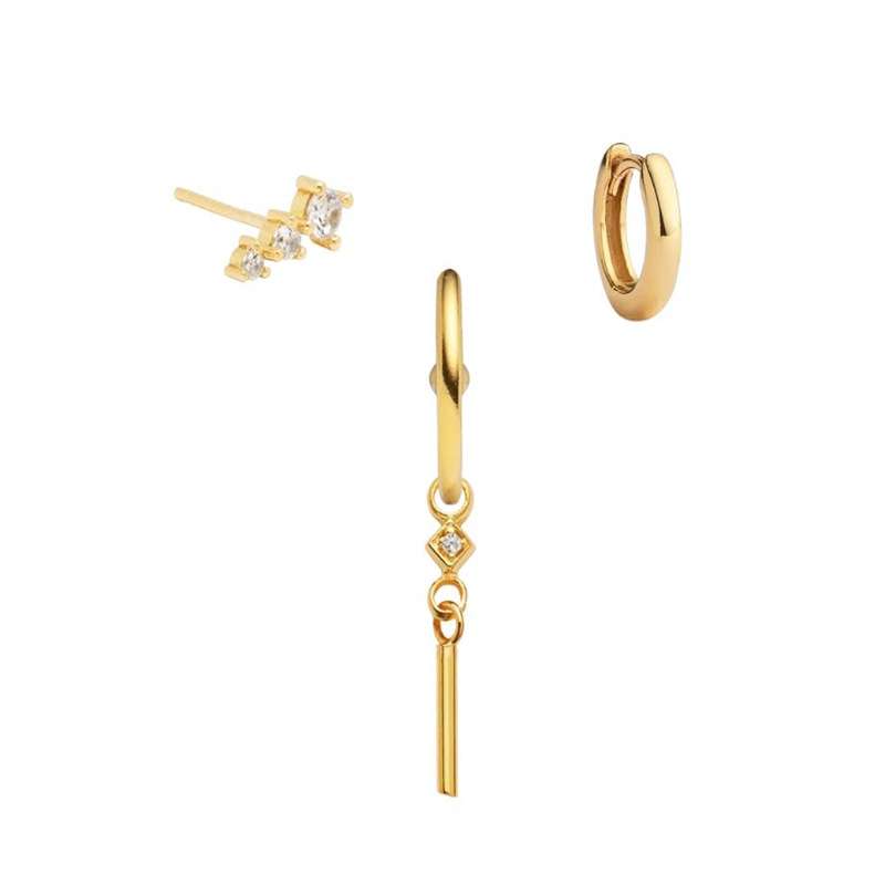 Set of gold earrings on a white background