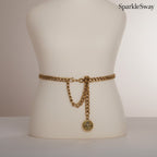 Gold chain belt on a mannequin with 'SparkleSway' branding.