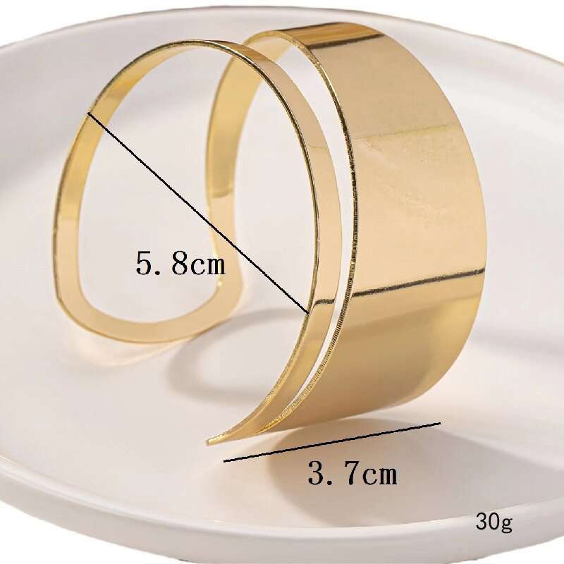 Gold bracelet with measurements on a white background