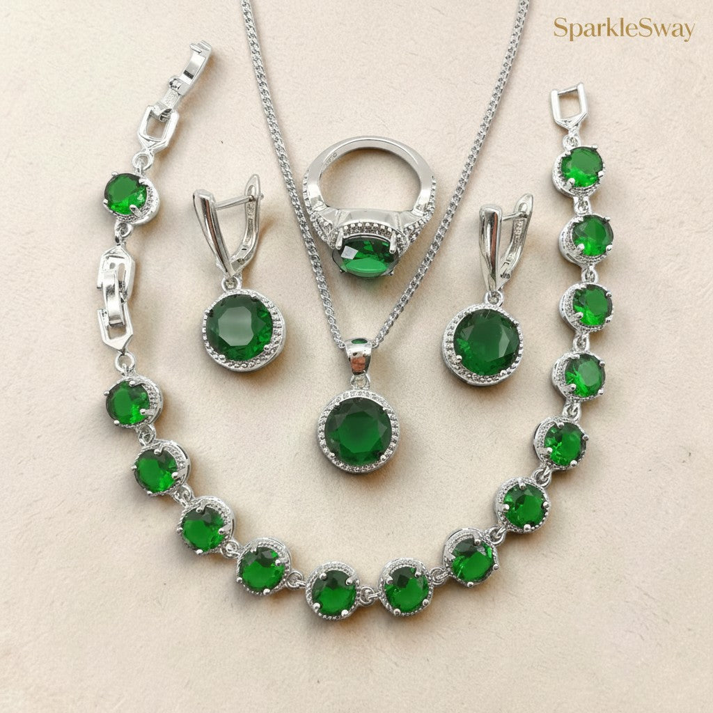 Jewelry set with green gemstones and silver accents on a beige background, featuring the brand 'SparkleSway'.