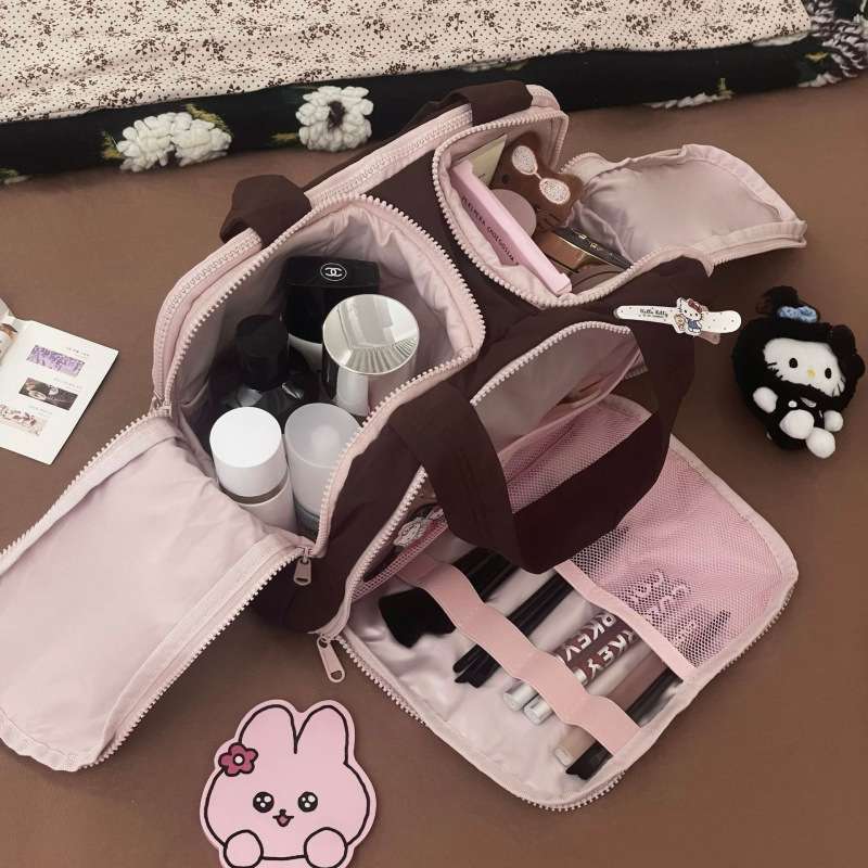 Makeup bag with various items on a brown surface