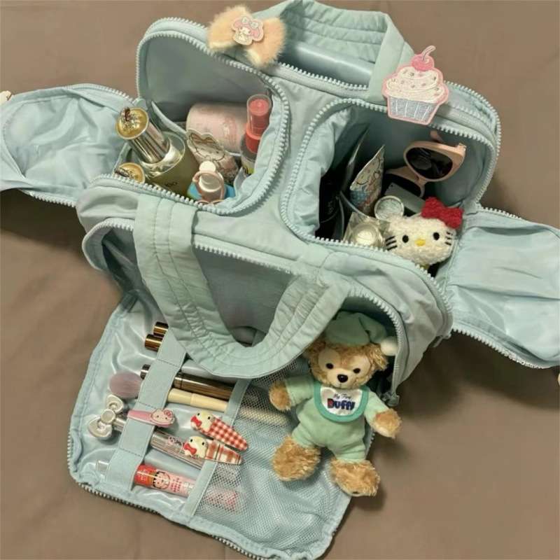 Light blue makeup organizer with various items including a teddy bear and small toys.