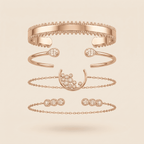 A set of five rose gold jewelry pieces, including two cuff bracelets, an open bangle with teardrop gemstones, a crescent moon with a cluster of clear stones, a delicate chain bracelet, and a matching chain link bracelet, arranged vertically on a light beige background.