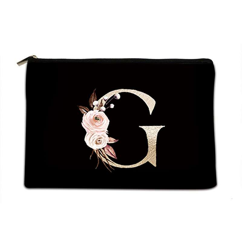 Black pouch with floral design and letter 'G' on a white background