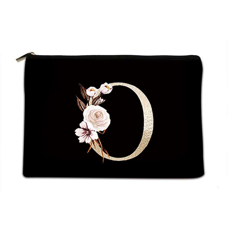 Black pouch with floral design and gold letter 'D' on a white background