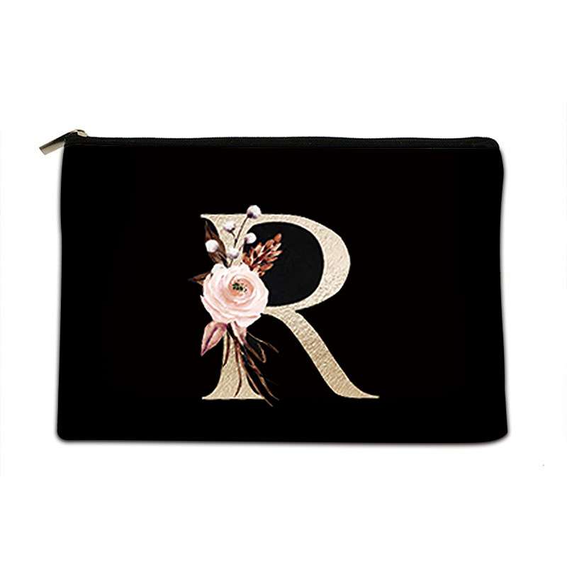 Black pouch with gold letter 'R' and floral design on a white background