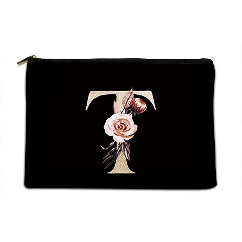 Black pouch with floral letter 'T' design on a white background