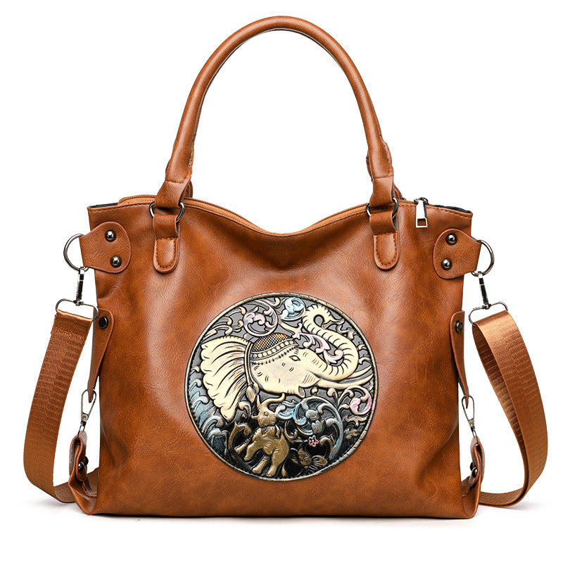 Retro Chinese Style Graceful And Fashionable Soft Bread leather handbag with elephant design in brown color.