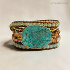 Stack of bracelets with a large turquoise stone on a beige background, branded 'SparkleSway'.