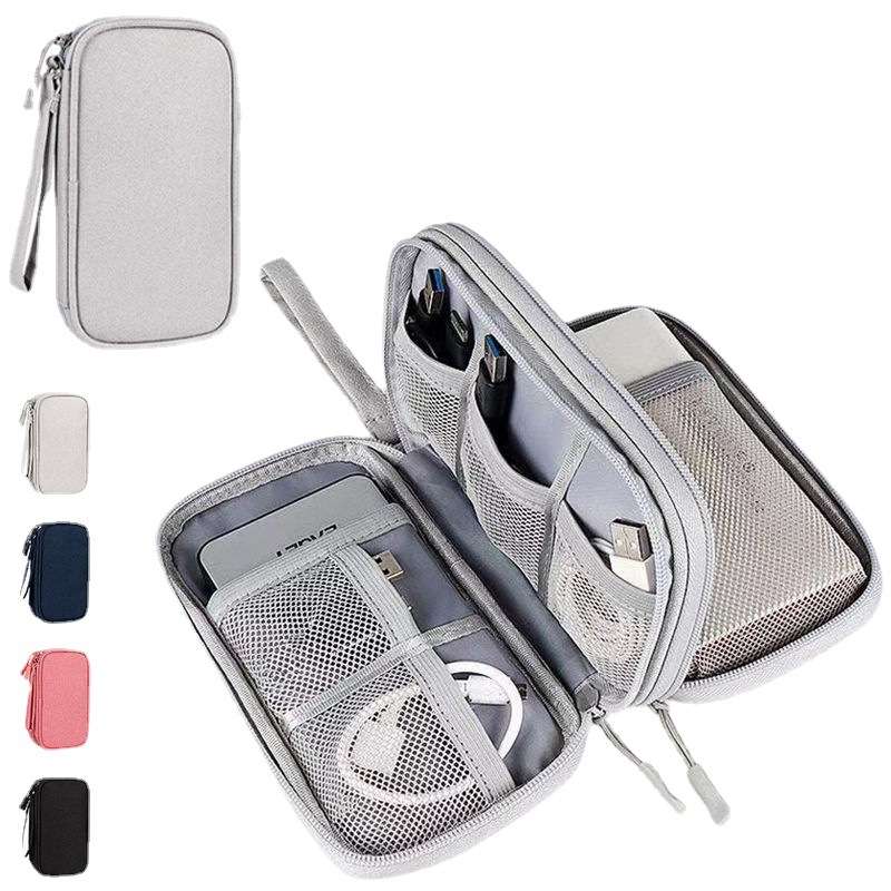 Gray travel case with compartments for electronic devices on a white background