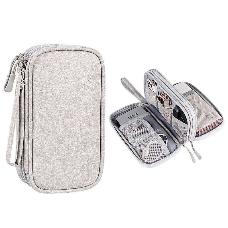Gray travel organizer with compartments on a white background