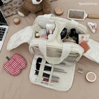 Sparklesway.co.uk cream nylon travel makeup bag with multiple compartments and brush holders, shown with makeup and accessories.