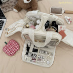 Sparklesway.co.uk cream travel makeup bag with multiple compartments and brush holders, filled with cosmetics.