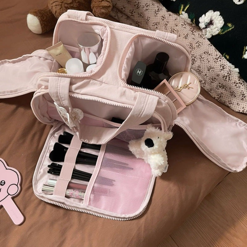 Sparklesway.co.uk pink travel makeup bag with multiple compartments, makeup brushes, and cosmetics.
